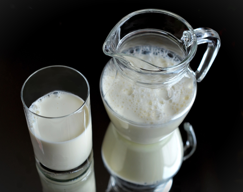 Glass and pitcher of milk