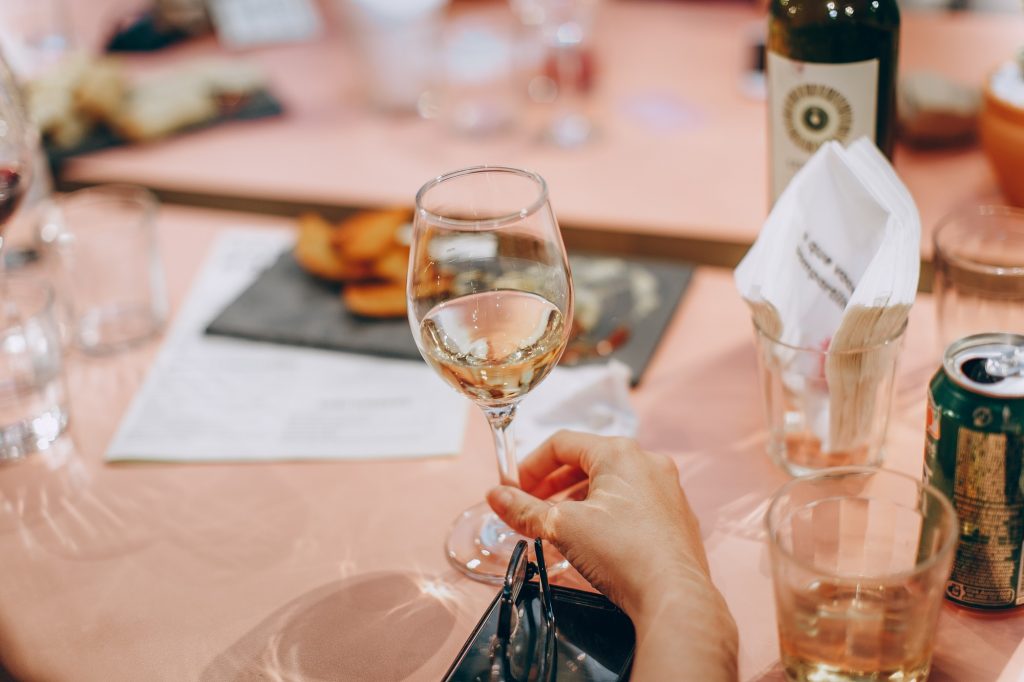 person holding wine glass on table at a restaurant